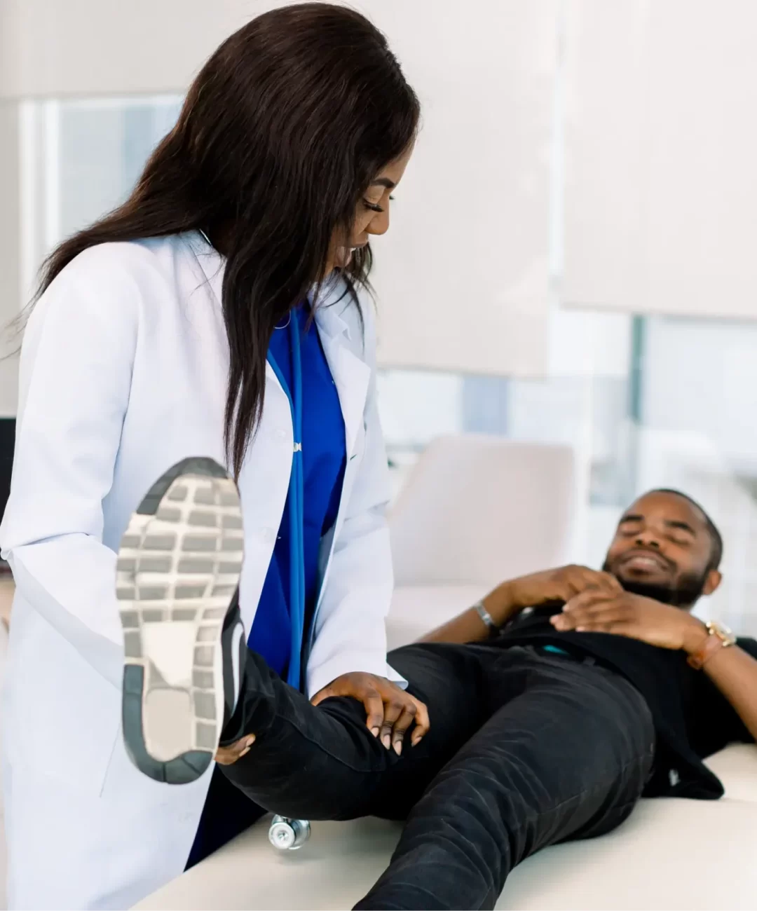 african-woman-doctor-orthopedist-examining-patient-2024-12-13-13-45-00-utc