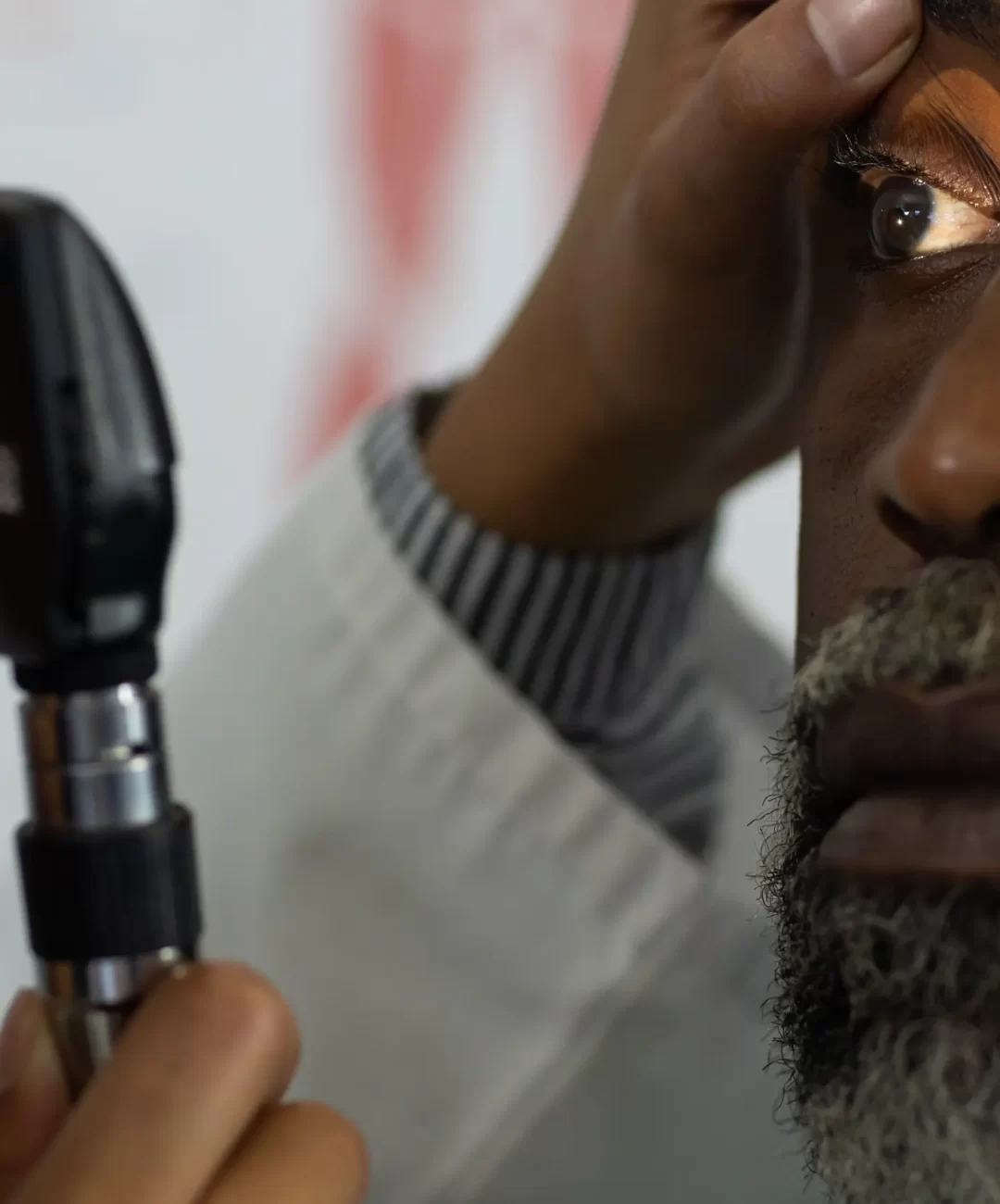 biracial-female-doctor-using-funduscope-and-examin-2023-11-27-05-09-40-utc